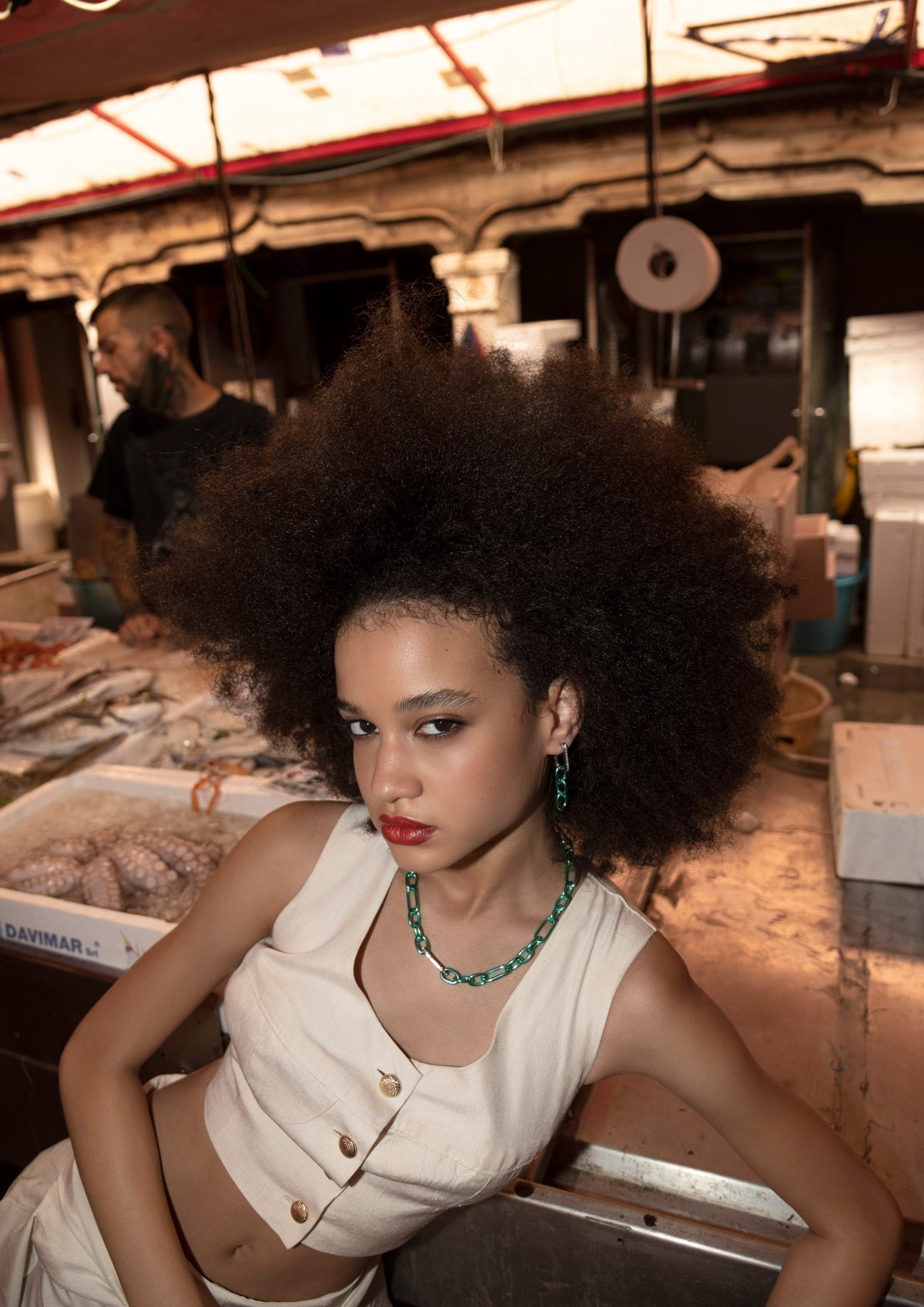 DARKAI Raw Energy Lookbook SS22 Woman at fish market wearing gold chain necklace