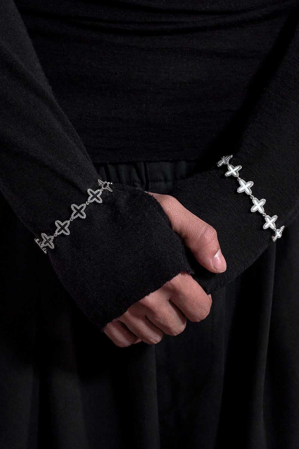 Clover tennis chain bracelet with 18kt white gold coating and hand-set stones in diamond white. Finished with hand painted black enamel and lobster clasp with logo