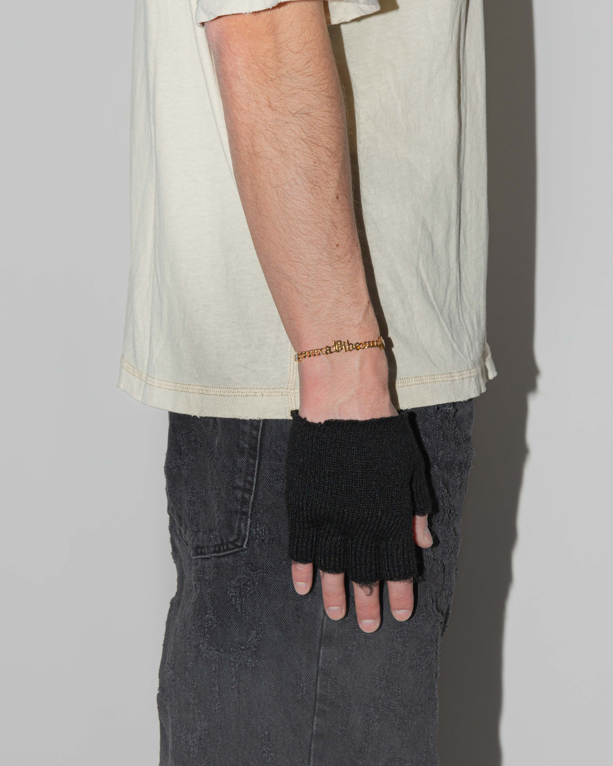 A Vibe cuban chain bracelet with 18kt yellow gold coating, mixed shape bezel stones in diamond white, yellow, garnet, tanzanite and "A Vibe" central metal tag. Lobster clasp with logo