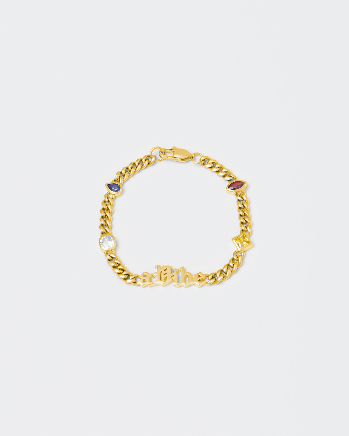 A Vibe cuban chain bracelet with 18kt yellow gold coating, mixed shape bezel stones in diamond white, yellow, garnet, tanzanite and "A Vibe" central metal tag. Lobster clasp with logo